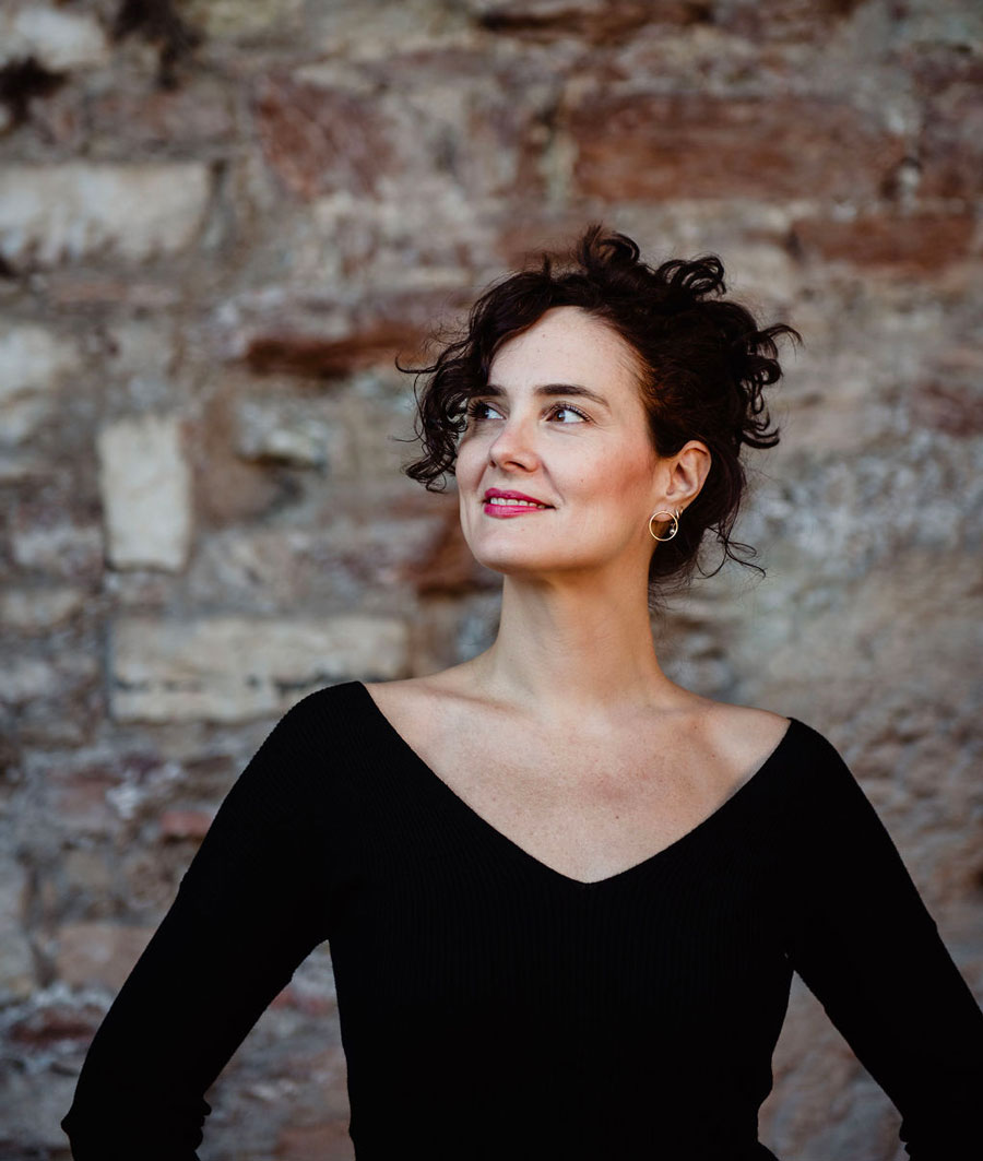 Ritratto di Irene Rizzi che sorride e rivolge il suo sguardo in alto a sinistra
